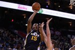 OAKLAND, CA - JANUARY 07:  Derrick Favors #15 of the Utah Jazz shoots over David Lee #10 of the Golden State Warriors at Oracle Arena on January 7, 2012 in Oakland, California.  NOTE TO USER: User expressly acknowledges and agrees that, by downloading and or using this photograph, User is consenting to the terms and conditions of the Getty Images License Agreement.  (Photo by Ezra Shaw/Getty Images)