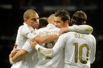 MADRID, SPAIN - MARCH 18:   Karim Benzema (C) of Real Madrid celebrates with Pepe (L), Mesut Ozil (R) and Cristiano Ronaldo (2nd R) after scoring Real's opening goal during the La Liga match between Real Madrid CF and Malaga CF at Estadio Santiago Bernabeu on March 18, 2012 in Madrid, Spain.  (Photo by Denis Doyle/Getty Images)