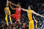 LOS ANGELES, CA - DECEMBER 19:  Chris Paul #3 of the Los Angeles Clippers drives to the basket on Metta World Peace #15 and Pau Gasol #16 of the Los Angeles Lakers at Staples Center on December 19, 2011 in Los Angeles, California.  The Clippers beat the Lakers 114-95.  (Photo by Harry How/Getty Images)