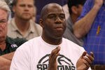 PHOENIX, AZ - MARCH 22:  Basketball hall-of-famer Earvin 'Magic' Johnson cheers on his alma mater the Michigan State Spartans as the Spartans take on the Louisville Cardinals during the 2012 NCAA Men's Basketball West Regional Semifinal game at US Airways Center on March 22, 2012 in Phoenix, Arizona.  (Photo by Christian Petersen/Getty Images)