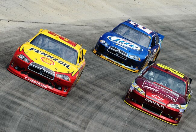 BRISTOL, TN - MARCH 18:  A.J. Allmendinger, driver of the #22 Shell/Pennzoil Dodge, Jeff Gordon, driver of the #24 Drive to End Hunger Chevrolet, and Brad Keselowski, driver of the #2 Miller Lite Dodge, race during the NASCAR Sprint Cup Series Food City 500 at Bristol Motor Speedway on March 18, 2012 in Bristol, Tennessee.  (Photo by Jared C. Tilton/Getty Images)