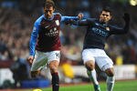 BIRMINGHAM, ENGLAND - FEBRUARY 12: Stiliyan Petrov of Aston Villa is tackled by Sergio Aguero of Man City during the Barclays Premier league match between Aston Villa and Manchester City at Villa Park on February 12, 2012 in Birmingham, England.  (Photo by Michael Regan/Getty Images)
