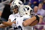 ARLINGTON, TX - OCTOBER 28:  Players of the BYU Cougars celebrate during a game against the TCU Horned Frogs at Cowboys Stadium on October 28, 2011 in Arlington, Texas. The TCU Horned Frogs defeated the BYU Cougars 38-28.  (Photo by Sarah Glenn/Getty Images)