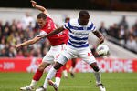 LONDON, ENGLAND - MARCH 31:  Aaron Ramsey of Arsenal and Nedum Onuoha of Queens Park Rangers battle for the ball during the Barclays Premier League match between Queens Park Rangers and Arsenal at Loftus Road on March 31, 2012 in London, England.  (Photo by Ian Walton/Getty Images)