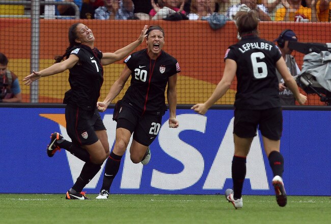 DRESDEN, GERMANY - JULY 10: Shannon Boxx (L) of USA celebrate their team opening goal during the FIFA Women's World Cup 2011 Quarter Final match between Brazil and USA at Rudolf-Harbig-Stadion on July 10, 2011 in Dresden, Germany. (Photo by Martin Rose/Getty Images)