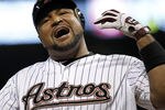HOUSTON - SEPTEMBER 12:  Carlos Lee #45 of the Houston Astros reacts after being hit in the hand by pitcher Roy Oswalt #45 in the seventh inning at Minute Maid Park on September 12, 2011 in Houston, Texas.  (Photo by Bob Levey/Getty Images)