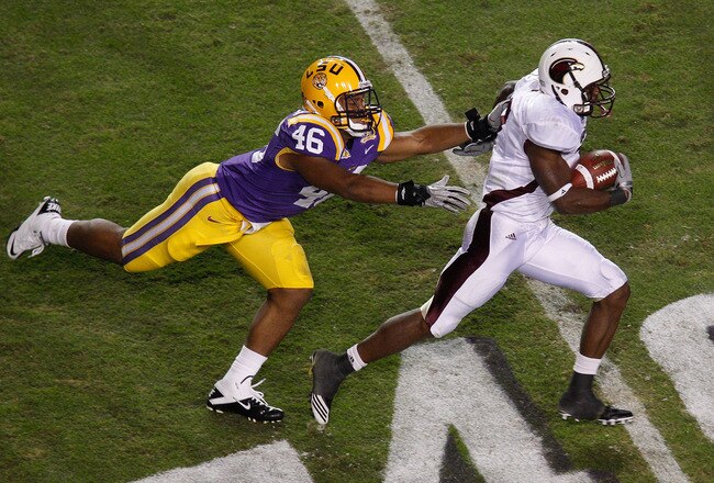 BATON ROUGE, LA - NOVEMBER 13:  Jyruss Edwards #7 of the University of Louisiana-Monroe Warhawks avoids a tackle by Kevin Minter #46 of the Louisiana State University Tigers at Tiger Stadium on November 13, 2010 in Baton Rouge, Louisiana.  The Tigers defeated the Warhawks 51-0.    (Photo by Chris Graythen/Getty Images)
