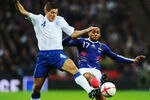 LONDON, ENGLAND - NOVEMBER 17:  Andy Carroll of England battles with Yann M'Vila of France during the international friendly match between England and France at Wembley Stadium on November 17, 2010 in London, England.  (Photo by Mike Hewitt/Getty Images)