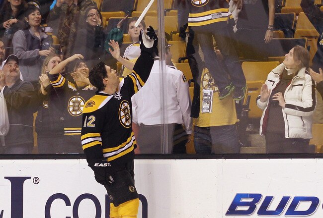 BOSTON, MA - MARCH 19:  Brian Rolston #12 of the Boston Bruins hands a fan his stick after being named first star of the game against the Toronto Maple Leafs  at the TD Garden on March 19, 2012 in Boston, Massachusetts.  The Bruins defeated the Maple Leafs 8-0.  (Photo by Bruce Bennett/Getty Images)