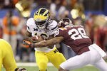 NEW ORLEANS, LA - JANUARY 03:  Denard Robinson #16 of the Michigan Wolverines runs the ball against Alonzo Tweedy #28 of the Virginia Tech Hokies during the Allstate Sugar Bowl at Mercedes-Benz Superdome on January 3, 2012 in New Orleans, Louisiana.  (Photo by Matthew Stockman/Getty Images)