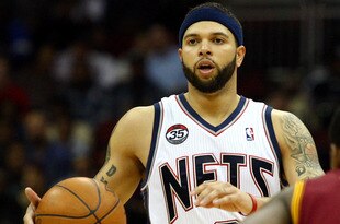 NEWARK, NJ - MARCH 19:  Deron Williams #8 of the New Jersey Nets brings the ball up court against Kyrie Irving #2 of the Cleveland Cavaliersat Prudential Center on March 19, 2012 in Newark, New Jersey.  NOTE TO USER: User expressly acknowledges and agrees that, by downloading and or using this photograph, User is consenting to the terms and conditions of the Getty Images License Agreement.  (Photo by Chris Chambers/Getty Images)