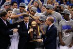 NEW ORLEANS, LA - APRIL 02:  Head coach John Calipari and Kentucky President Eli Capilouto hold the trophy after the Wildcats defeat the Kansas Jayhawks 67-59 in the National Championship Game of the 2012 NCAA Division I Men's Basketball Tournament at the Mercedes-Benz Superdome on April 2, 2012 in New Orleans, Louisiana.  (Photo by Chris Graythen/Getty Images)