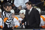 BOSTON, MA - JANUARY 13:  Head coach Peter Laviolette of the Philadelphia Flyers talks with referee Brad Watson before the start of the second period against the Boston Bruins on January 11, 2011 at the TD Garden in Boston, Massachusetts.  (Photo by Elsa/Getty Images)