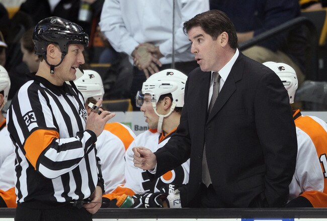 BOSTON, MA - JANUARY 13:  Head coach Peter Laviolette of the Philadelphia Flyers talks with referee Brad Watson before the start of the second period against the Boston Bruins on January 11, 2011 at the TD Garden in Boston, Massachusetts.  (Photo by Elsa/Getty Images)