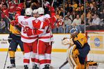 NASHVILLE, TN - MARCH 10:  Drew Miller #20 and Brendan Smith #2 of the Detroit Red Wings celebrate scoring a goal against Pekka Rinne #35 of the Nashville Predators at Bridgestone Arena on March 10, 2012 in Nashville, Tennessee.  (Photo by Frederick Breedon/Getty Images)
