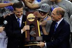NEW ORLEANS, LA - APRIL 02:  Head coach John Calipari and Kentucky President Eli Capilouto hold the trophy after the Wildcats defeat the Kansas Jayhawks 67-59 in the National Championship Game of the 2012 NCAA Division I Men's Basketball Tournament at the Mercedes-Benz Superdome on April 2, 2012 in New Orleans, Louisiana.  (Photo by Chris Graythen/Getty Images)