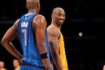 LOS ANGELES, CA - JANUARY 16:  Kobe Bryant #24 of the Los Angeles Lakers laughs with Lamar Odom #7 of the Dallas Mavericks at Staples Center on January 16, 2012 in Los Angeles, California.  NOTE TO USER: User expressly acknowledges and agrees that, by downloading and or using this photograph, User is consenting to the terms and conditions of the Getty Images License Agreement.  (Photo by Stephen Dunn/Getty Images)