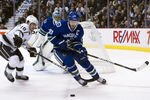 VANCOUVER, CANADA - JANUARY 17: Henrik Sedin #33 of the Vancouver Canucks picks up the loose puck while being pressured by Mike Richards #10 of the Los Angeles Kings during the first period in NHL action on January 17, 2012 at Rogers Arena in Vancouver, British Columbia, Canada.  (Photo by Rich Lam/Getty Images)