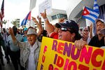 MIAMI, FL - APRIL 10:  Protesters rally outside a press conference held by Manager Ozzie Guillen for comments made about Fidel Castro at Marlins Park on April 10, 2012 in Miami, Florida. The Marlins suspended Guillen for five games over his pro-Castro comments.  (Photo by Mike Ehrmann/Getty Images)