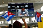 MIAMI, FL - APRIL 10:  Protesters rally outside as Miami Marlins Manager Ozzie Guillen seen on a screen speaks during a press conference about comments made about Fidel Castro at Marlins Park on April 10, 2012 in Miami, Florida. The Marlins suspended Guillen for five games over his pro-Castro comments.  (Photo by Mike Ehrmann/Getty Images)