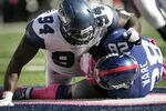 EAST RUTHERFORD, NJ - OCTOBER 9:  Anthony Hargrove #94 of the Seattle Seahawks tackles Danny Ware #28 of the New York Giants in the end zone for a saftey during a game at MetLife Stadium on October 9, 2011 in East Rutherford, New Jersey. (Photo by Rich Schultz /Getty Images)
