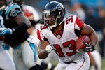 CHARLOTTE, NC - DECEMBER 11:  Michael Turner #33 of the Atlanta Falcons runs with the ball against the Carolina Panthers during their game at Bank of America Stadium on December 11, 2011 in Charlotte, North Carolina.  (Photo by Streeter Lecka/Getty Images)