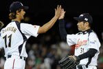 LOS ANGELES, CA - MARCH 22:  Pitcher Yu Darvish #11 and Ichiro Suzuki #51 of Japan celebrate after defeating the United States to win the semifinal game of the 2009 World Baseball Classic on March 22, 2009 at Dodger Stadium in Los Angeles, California. Japan defeated the United States 9-4.  (Photo by Kevork Djansezian/Getty Images)