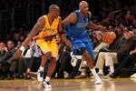 LOS ANGELES, CA - JANUARY 16: Lamar Odom #7 of the Dallas Mavericks drives down the court against Kobe Bryant #24 of the Los Angeles Lakers at Staples Center on January 16, 2012 in Los Angeles, California. The Lakers won 73-70.  NOTE TO USER: User expressly acknowledges and agrees that, by downloading and or using this photograph, User is consenting to the terms and conditions of the Getty Images License Agreement.  (Photo by Stephen Dunn/Getty Images)