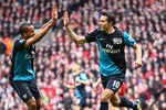 LIVERPOOL, ENGLAND - MARCH 03:  Robin van Persie of Arsenal celebrates scoring the equalising goal with teammate Theo Walcott (L) during the Barclays Premier League match between Liverpool and Arsenal at Anfield on March 3, 2012 in Liverpool, England.  (Photo by Clive Mason/Getty Images)