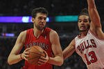 CHICAGO, IL - MARCH 24:  Andrea Bargnani #7 of the Toronto Raptors drives around Joakim Noah #13  of the Chicago Bulls at the United Center on March 24, 2012 in Chicago, Illinois. The Bulls defeated the Rators 102-101 in overtime. NOTE TO USER: User expressly acknowledges and agrees that, by downloading and or using this photograph, User is consenting to the terms and conditions of the Getty Images License Agreement.  (Photo by Jonathan Daniel/Getty Images)