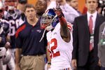 INDIANAPOLIS, IN - FEBRUARY 05:  Mario Manningham #82 of the New York Giants signals first down after catching a 38 yard pass from Eli Manning #10 over Patrick Chung #25 and Brian Witherspoon #29 in the fourth quarter during Super Bowl XLVI at Lucas Oil Stadium on February 5, 2012 in Indianapolis, Indiana.  (Photo by Andy Lyons/Getty Images)
