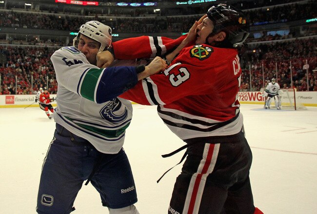 CHICAGO, IL - NOVEMBER 06: Daniel Carcillo #13 of the Chicago Blackhawks and Aaron Volpatti #54 of the Vancouver Canucks fight in the second period at the United Center on November 6, 2011 in Chicago, Illinois. (Photo by Jonathan Daniel/Getty Images)
