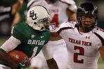 ARLINGTON, TX - NOVEMBER 26:  Kendall Wright #1 of the Baylor Bears runs the ball against Cornelius Douglas #2 of the Texas Tech Red Raiders at Cowboys Stadium on November 26, 2011 in Arlington, Texas.  (Photo by Ronald Martinez/Getty Images)