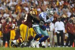LANDOVER - SEPTEMBER 12:  London Fletcher #59 of the Washington Redskins tackles Jason Witten #82 of the Dallas Cowboys during the NFL season opener at FedExField on September 12, 2010 in Landover, Maryland. The Redskins defeated the Cowboys 13-7. (Photo by Larry French/Getty Images)