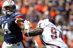 AUBURN, AL - SEPTEMBER 10:  Quarterback Barrett Trotter #14 of the Auburn Tigers throws a pass while under pressure from defensive lineman Fletcher Cox #94 of the Mississippi State Bulldogs in the first quarter on September 10, 2011 at Jordan-Hare Stadium in Auburn, Alabama. (Photo by Butch Dill/Getty Images)