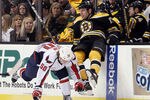 BOSTON, MA - MARCH 29:  Milan Lucic #17 of the Boston Bruins is hit by Cody Eakin #50 of the Washington Capitals on March 29, 2012 at TD Garden in Boston, Massachusetts.  (Photo by Elsa/Getty Images)