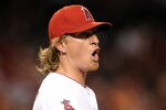 ANAHEIM, CA - APRIL 16:  Jered Weaver #36 of the Los Angeles Angels reacts as Seth Smith #15 of the Oakland Athletics is called safe at first base during the fourth inning at Angel Stadium of Anaheim on April 16, 2012 in Anaheim, California.  (Photo by Harry How/Getty Images)