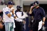 ARLINGTON, TX - DECEMBER 24:  Quarterback Tony Romo #9 of the Dallas Cowboys stands on the sidelines with head coach Jason Garrett as the Dallas Cowboys take on the Philadelphia Eagles at Cowboys Stadium on December 24, 2011 in Arlington, Texas. Romo hurt his right hand in the first quarter and sat out the rest of the game.  (Photo by Tom Pennington/Getty Images)