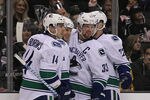 LOS ANGELES, CA - DECEMBER 31:  (L-R) Alexandre Burrows #14, Kevin Bieksa #3, Henrik Sedin #33 and Daniel Sedin #22 of the Vancouver Canucks celebrate Bieksa's first-period goal against the Los Angeles Kings in the first period during the NHL game at Staples Center on December 31, 2011 in Los Angeles, California.  (Photo by Victor Decolongon/Getty Images)