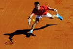 BENIDORM, SPAIN - MARCH 07:  Novak Djokovic of Serbia casts his shadow on the clay as he stretches to return a backhand to David Ferrer of Spain during day one of the Davis Cup World Group first round tie between Spain and Serbia at the Parque Tematico Terra Mitica on March 7, 2009 in Benidorm, Spain. Djokovic lost his match against Ferrer in three sets 6-3, 6-3 and 7-6, giving Spain a 1-0 lead over Serbia.  (Photo by Jasper Juinen/Getty Images)