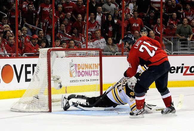 WASHINGTON, DC - APRIL 16:  Brooks Laich #21 of the Washington Capitals scores a goal against Tim Thomas #30 of the Boston Bruins in Game Three of the Eastern Conference Quarterfinals during the 2012 NHL Stanley Cup Playoffs at Verizon Center on April 16, 2012 in Washington, DC.  (Photo by Patrick McDermott/Getty Images)
