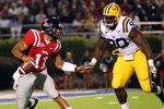 OXFORD, MS - NOVEMBER 19: Barry Brunetti #11 of the Ole Miss Rebels scrambles with the ball against Michael Brockers #90 of the LSU Tigers on November 19, 2011 at Vaught-Hemingway Stadium in Oxford, Mississippi.  (Photo by Joe Murphy/Getty Images)
