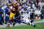 LANDOVER, MD - DECEMBER 24:   Jabar Gaffney #10 of the Washington Redskins breaks the tackle of Jamarca Sanford #33 of the Minnesota Vikings during a game at FedExField on December 24, 2011 in Landover, Maryland.  (Photo by Patrick McDermott/Getty Images)