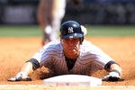 NEW YORK, NY - APRIL 13:  Russell Martin #55 of the New York Yankees slides safely into third base against the Los Angeles Angels during the home opener at Yankee Stadium on April 13, 2012 in the Bronx borough of New York City.  (Photo by Nick Laham/Getty Images)