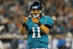 JACKSONVILLE, FL - DECEMBER 5:  Quarterback Blaine Gabbert #11 of the Jacksonville Jaguars salutes a touchdown run by running back Maurice Jones-Drew #32 against the San Diego Chargers in a Monday Night Football game December 5, 2011 at EverBank Field in Jacksonville, Florida.  (Photo by Al Messerschmidt/Getty Images)