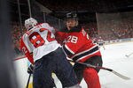 NEWARK, NJ - APRIL 17:  Anton Volchenkov #28 of the New Jersey Devils checks Tomas Kopecky #82 of the Florida Panthers in the first period in Game Three of the Eastern Conference Quarterfinals during the 2012 NHL Stanley Cup Playoffs at Prudential Center on April 17, 2012 in Newark, New Jersey.  (Photo by Bruce Bennett/Getty Images)