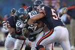CHICAGO, IL - DECEMBER 18: Justin Forsett #20 of the Seattle Seahawks is hit by (L-R) Lance Briggs #55, Israel Idonije #71 and Brian Urlacher #54 of the Chicago Bears at Soldier Field on December18, 2011 in Chicago, Illinois. The Seahawks defeated the Bears 38-14. (Photo by Jonathan Daniel/Getty Images)