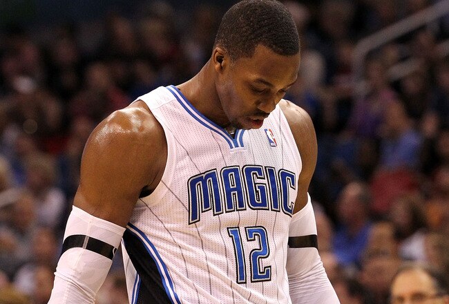 ORLANDO, FL - MARCH 13:  Dwight Howard #12 of the Orlando Magic walks off the court during the game against the Miami Heat at Amway Center on March 13, 2012 in Orlando, Florida.  NOTE TO USER: User expressly acknowledges and agrees that, by downloading and or using this photograph, User is consenting to the terms and conditions of the Getty Images License Agreement.  (Photo by Sam Greenwood/Getty Images)
