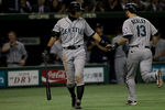TOKYO, JAPAN - MARCH 28:  Dustin Ackley #13 of the Seattle Mariners is congratulated by team mate Ichiro Suzuki #51 after hitting a home run in the fourth inning against the Oakland Athletics during the MLB Opening Series game between the Seattle Mariners and Oakland Athletics at Tokyo Dome on March 28, 2012 in Tokyo, Japan.  (Photo by Chris McGrath/Getty Images)