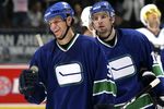 VANCOUVER, CANADA - OCTOBER 13:    Ryan Kesler #17 skates with teammate Kevin Bieksa #3 of the Vancouver Canucks as Bieksa celebrates his first NHL goal against the San Jose Sharks during their game at General Motors Place on October 13, 2006 in Vancouver, Canada.  San Jose defeated Vancouver 6 to 4. (Photo by Jeff Vinnick/Getty Images)
